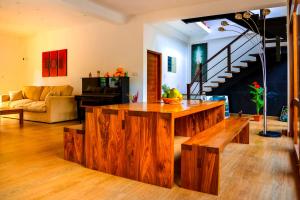 a living room with a wooden island in the middle at Kings Villa Galle in Galle