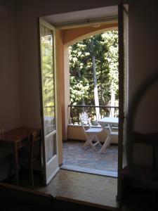 an open door to a patio with a table and chairs at Albergo Riva in Reno Di Leggiuno