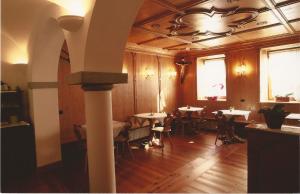 a room with tables and chairs in a restaurant at Cadore Haus in Auronzo di Cadore