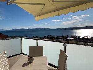 a balcony with a table and chairs and a view of the water at Luxury APP Anna ( near center) in Crikvenica