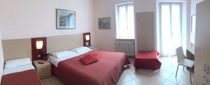 a hotel room with a bed and a television at Albergo Riva in Reno Di Leggiuno