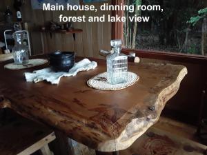 a wooden table with a bottle on top of it at karukinka in Chonchi
