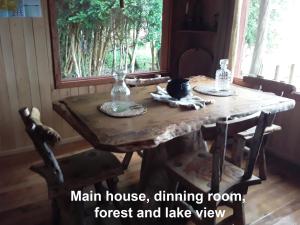 a wooden table with two glass bottles on top of it at karukinka in Chonchi