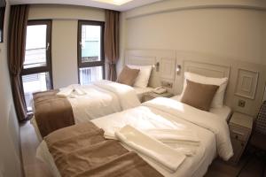 Postel nebo postele na pokoji v ubytování X-NELLYİ HOTEL