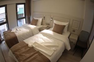 Postel nebo postele na pokoji v ubytování X-NELLYİ HOTEL