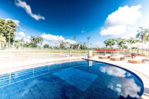 a large swimming pool with a blue sky at Golden Tulip Brasília Alvorada in Brasília
