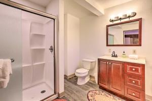 a bathroom with a toilet and a sink and a mirror at Quaint and Rustic A-Frame Less Than 5 Mi to Plumas-Eureka! in Plumas Eureka