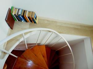 a spiral staircase with a book shelf with books at Apartment Tea in Preko