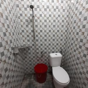 a small bathroom with a toilet and a shower at WIEN HOMESTAY CIREBON - B7 Family Homestay in Cirebon