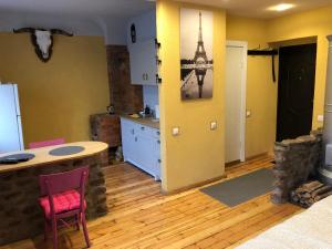 a kitchen with a table and chairs in a room at Schwanenburg rest in Gulbene