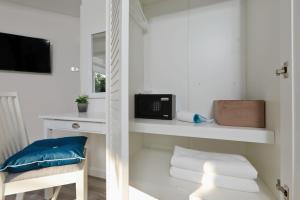 a white toilet sitting next to a white sink at Kata White Villas in Kata Beach