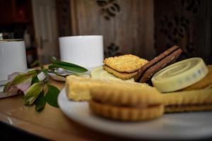 a plate of food with bread and waffles on a table at TLC Exmouth Bed and Breakfast in Exmouth