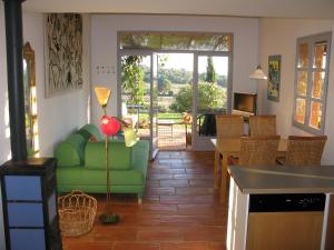 a living room with a green couch and a table at House With Garden And Sea View in La Londe-les-Maures
