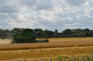 a green tractor working in a field at Lakeside Old Hunstanton in Hunstanton
