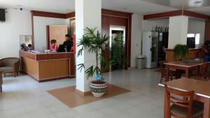 a lobby with a restaurant with tables and plants at Hotel Plaza Andalgala in Andalgalá +10 photos