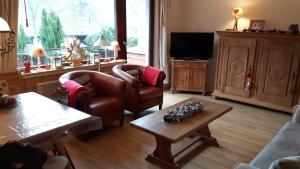 a living room with a couch and chairs and a table at Winterberg-Hasewinkel in Winterberg