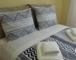 a close up of a bed with pillows on it at Rinconcito Roteńo in Rota