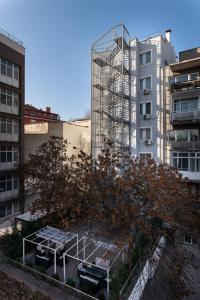 a tree in front of a tall building at A Hotels & Suite in Ankara