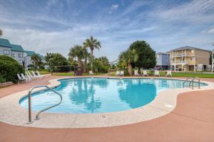 a large swimming pool with chairs in a resort at Plantation West Resort in Gulf Shores