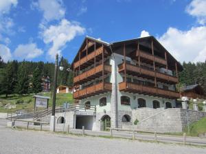 a building with balconies on the side of a mountain at RTA Torre Del Brenta in Madonna di Campiglio