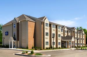 an exterior view of a building with a parking lot at Microtel Inn & Suites Bath in Bath