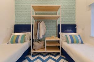 A bed or beds in a room at SorrentoVibes - Design Holiday Home in Sorrento city center