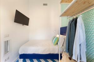 A bed or beds in a room at SorrentoVibes - Design Holiday Home in Sorrento city center