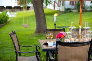 a wooden table with wine glasses and flowers on it at South Court Inn in Luray