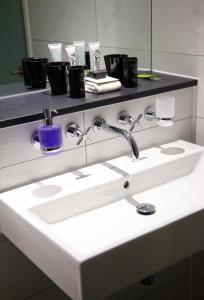 a bathroom with a sink and a mirror at Malmaison London in London