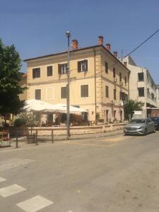 a large building with a car parked in front of it at Summer Home No. 8 in Fažana