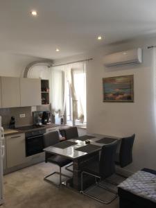a kitchen and dining room with a table and chairs at Summer Home No. 8 in Fažana