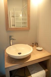 a bathroom with a sink and a mirror at Le Chateau De La Vierge in Bures-sur-Yvette