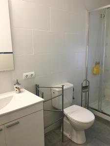 a white bathroom with a toilet and a shower at Casa de Huespedes la Peña in Ibiza Town +21 photos