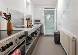 a kitchen with a stove and a refrigerator at Gairloch Sands Youth Hostel in Gairloch