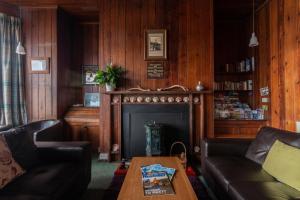 a living room filled with furniture and a fireplace at Gairloch Sands Youth Hostel in Gairloch