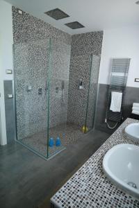 a bathroom with a shower and a sink at Villa Chelidonia in Karpathos +17 photos