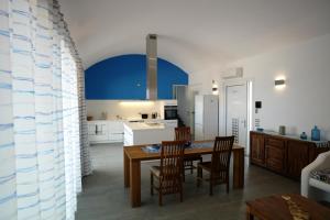 a kitchen and dining room with a table and chairs at Villa Chelidonia in Karpathos
