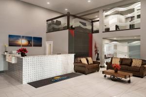 a living room with two couches and a counter at Days Inn by Wyndham Wainwright in Wainwright