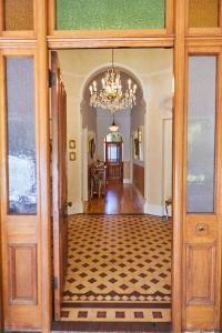 an open door to a room with a chandelier at Villa Puccini in Cape Town