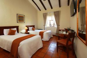 Cama ou camas em um quarto em San Agustin Monasterio de la Recoleta
