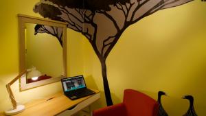 a room with a tree painted on the wall at Nubian Hostel in Athens