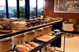a buffet line with many different types of food at Memmo Príncipe Real - Design Hotels in Lisbon