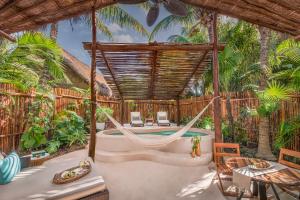 a villa with a hammock and a swimming pool at Viceroy Riviera Maya, a Luxury Villa Resort in Playa del Carmen