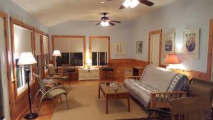 a living room with a couch and a table at TeelCoveCottageMaine in Saint George
