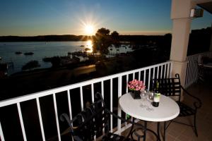 a balcony with a table with a view of the water at Bella Vista Suites Lake Geneva in Lake Geneva