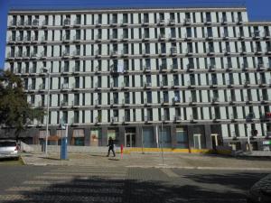 a man walks in front of a building at Entrecampos 6 in Lisbon