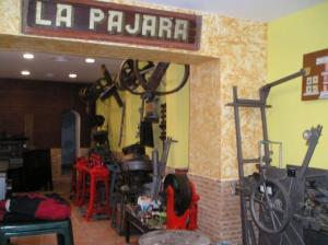 a garage with a bike hanging from a wall at Hostal Casa Museo La Pájara in Hellín