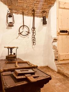 an old room with a table and a metal item on the wall at Ca' del Borgo in Venosa