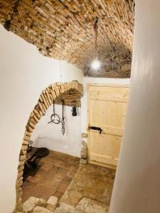 an archway in a room with a wooden door at Ca' del Borgo in Venosa