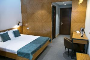Letto o letti in una camera di R&R Hotel